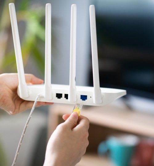 asian-girl-is-plugging-network-cable-into-wifi-transmitter