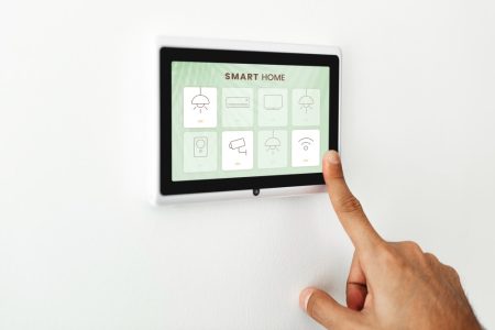 finger-pressing-smart-home-automation-panel-monitor